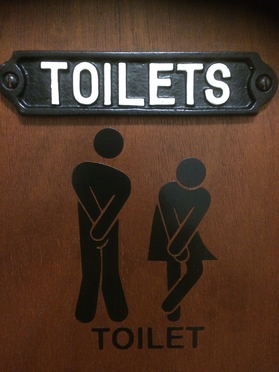 A restroom sign mounted on a dark wall.