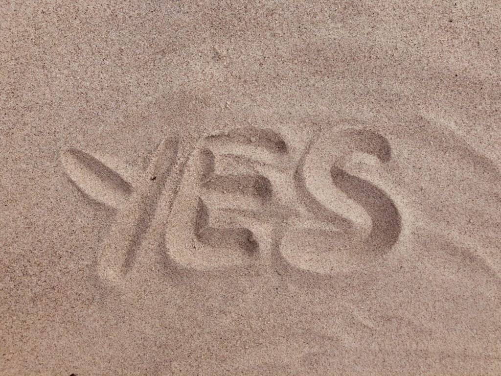 yes text on brown sand