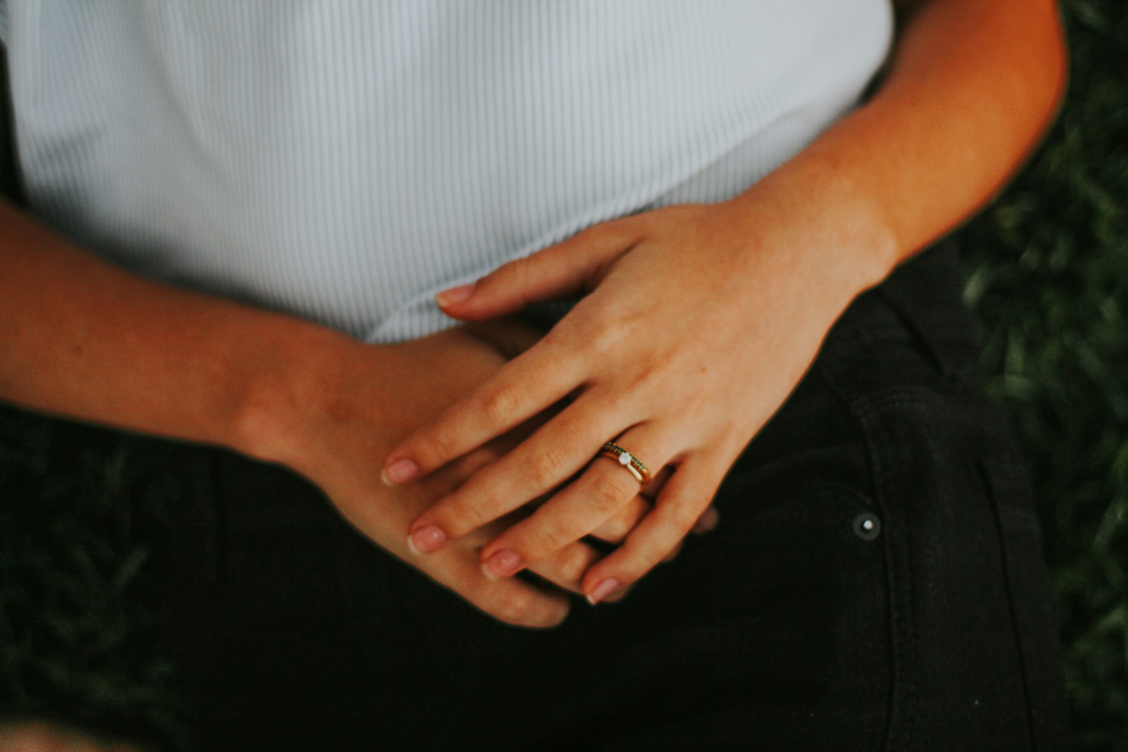 An adult with hands resting on the abdomen.