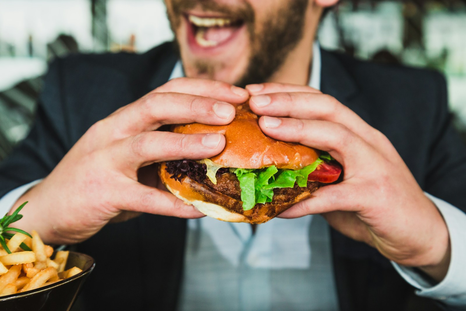 An adult eating a sandwich.