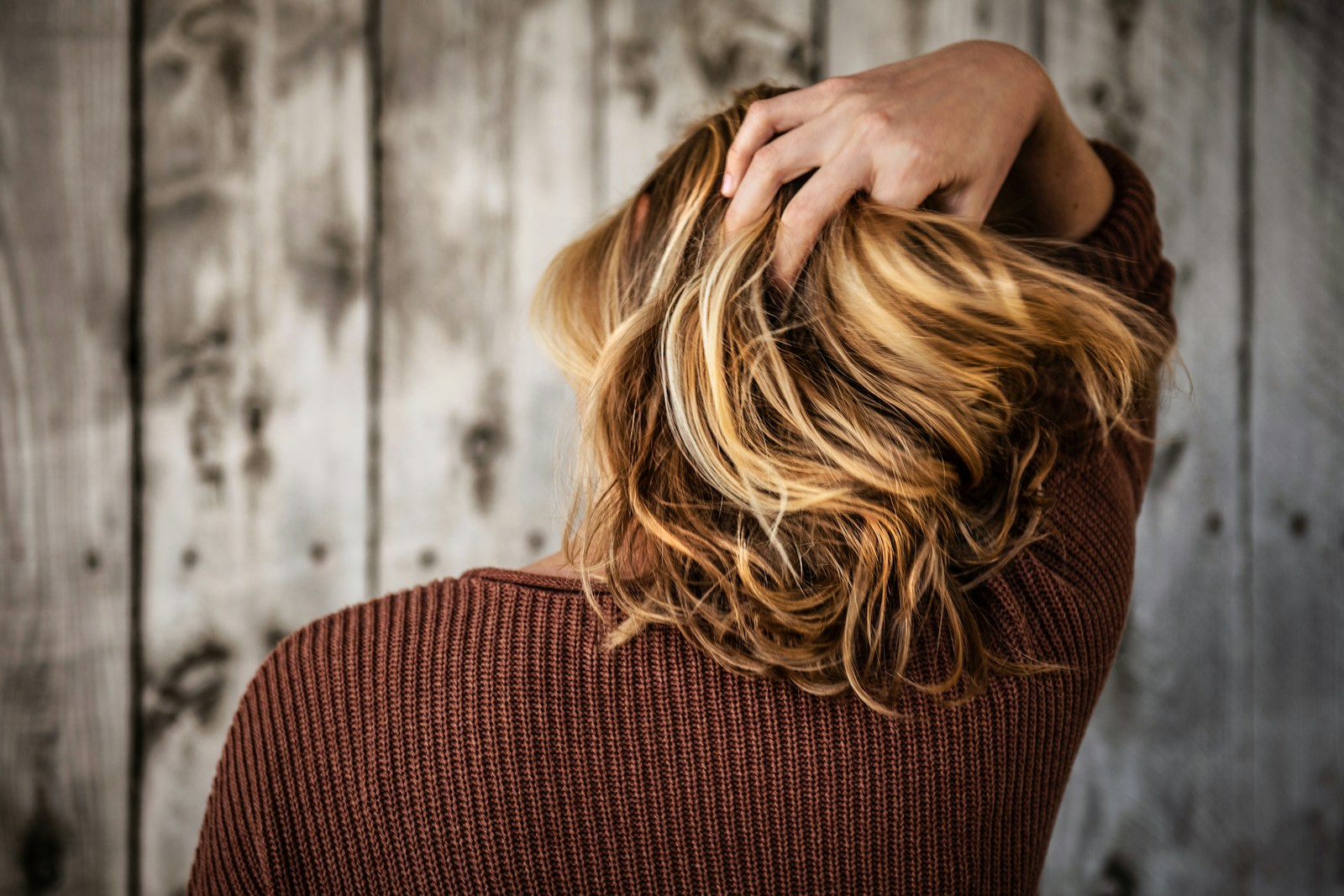 An adult with shoulder-length hair viewed from behind.