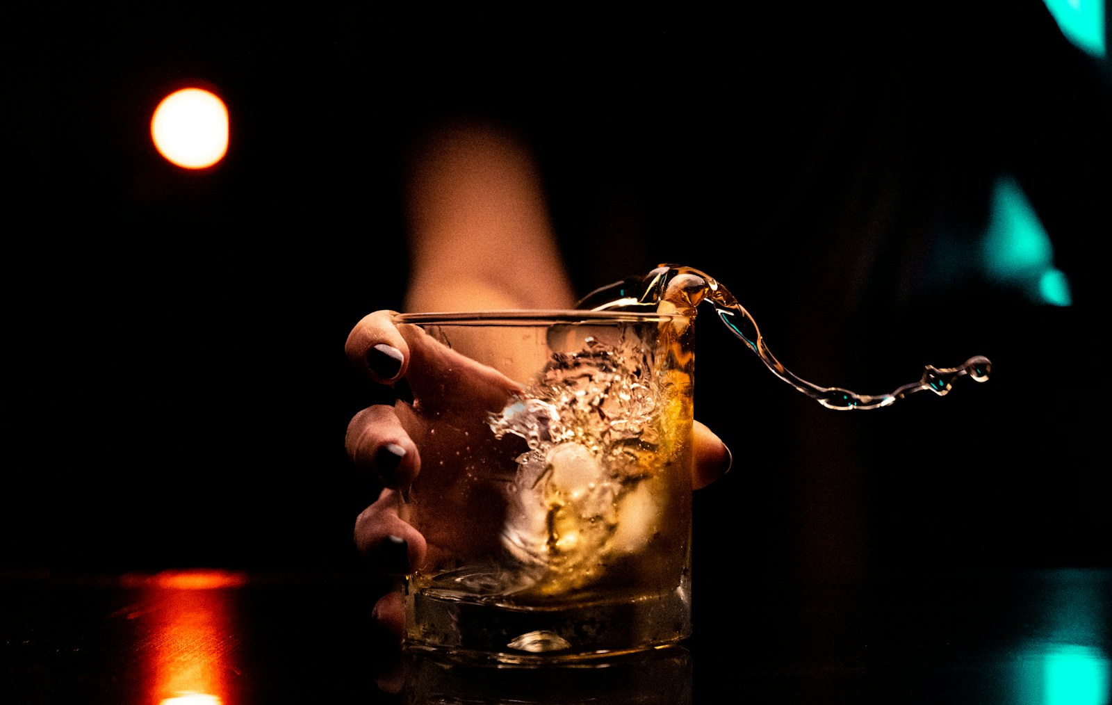 An alcoholic drink splashing in a glass.