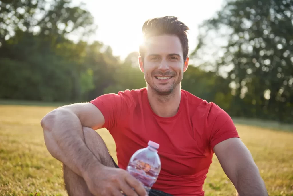 smiling-man-resting-after-workout-on-the-fresh-air-2026-03-13-04-16-06-utc