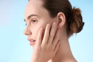 close up of woman with hand on her face utc