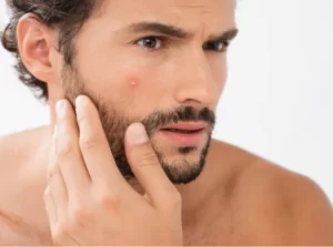 man-examining-face-touching-skin-with-tattooed-ar-2026-03-12-22-36-26-utc