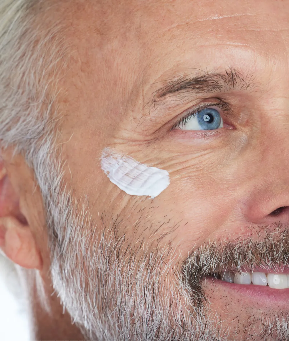 Older man with cream on his cheek