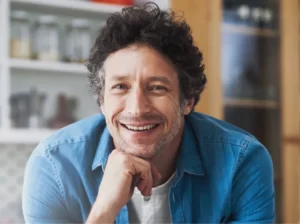smiling-man-leans-on-kitchen-countertop-at-home-2026-01-09-10-22-20-utc