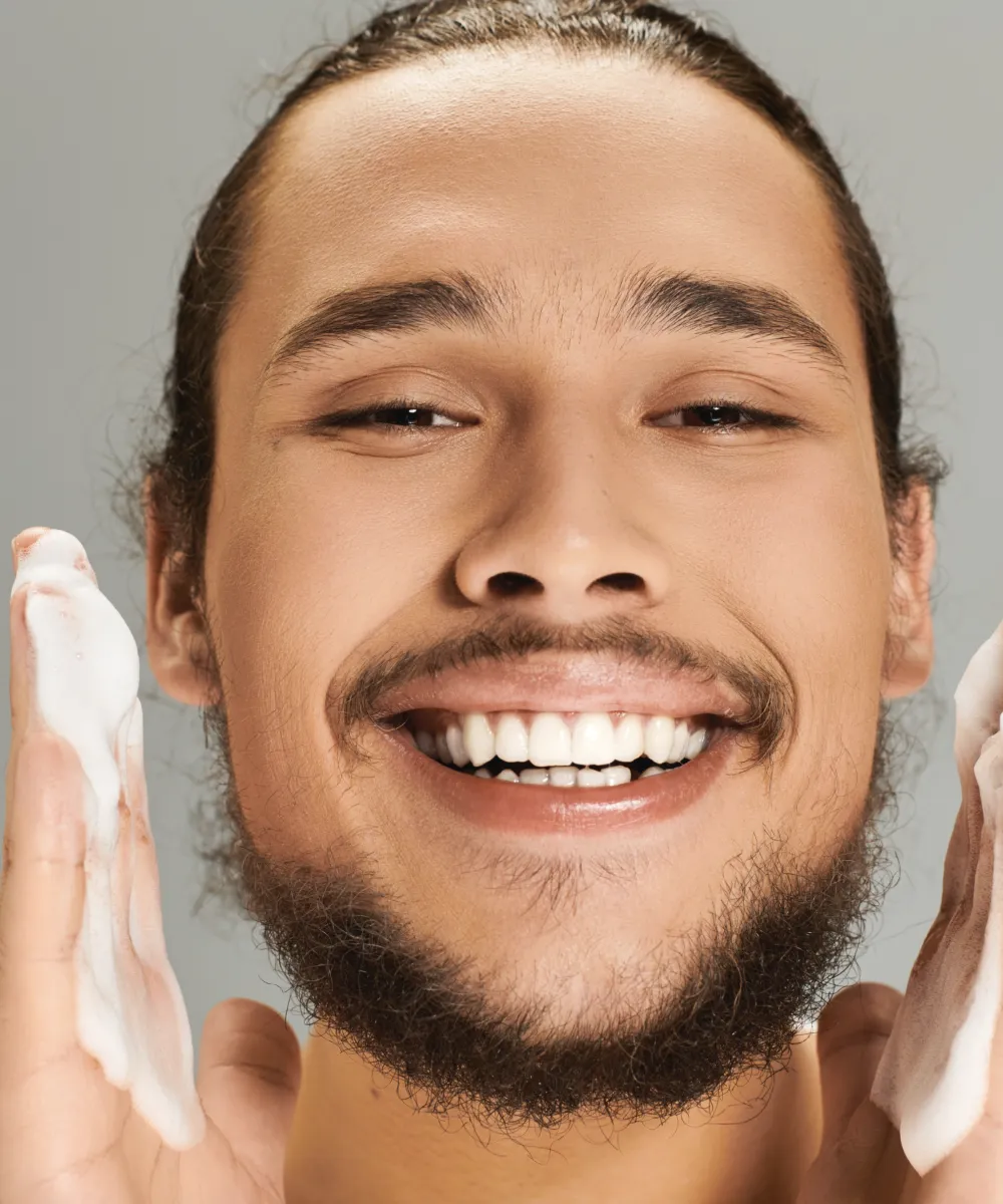 Man gently washing his face