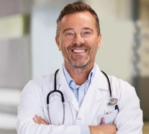 smiling-mature-doctor-in-hospital-hallway-2023-11-27-05-34-44-utc