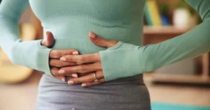 woman doing yoga pose indoors waist up shot utc