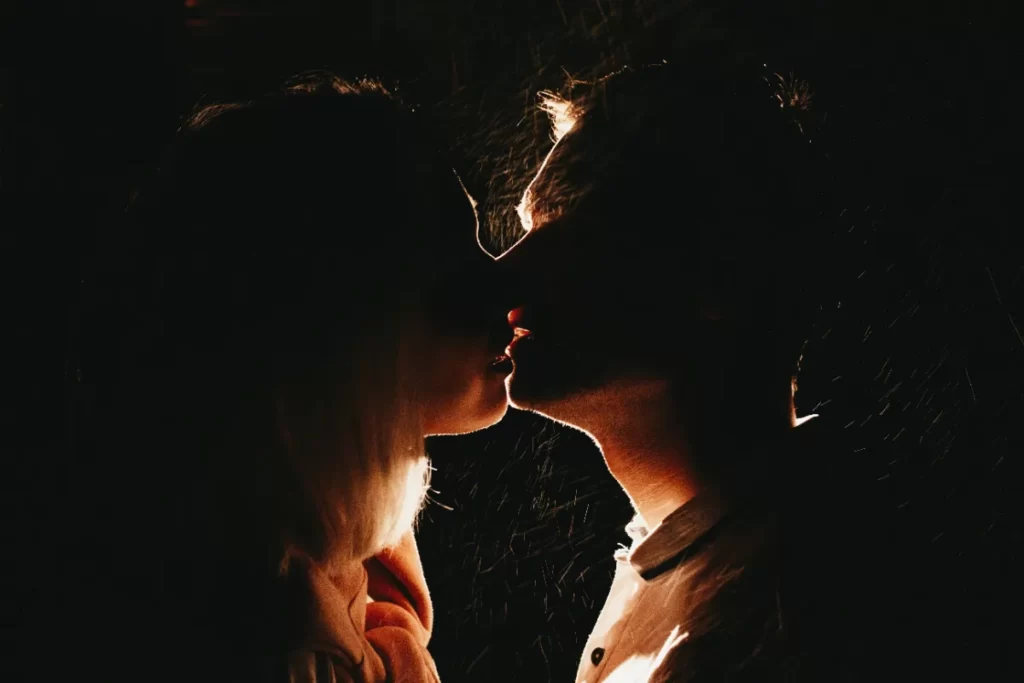 romantic couple silhouette embracing in dark urban utc