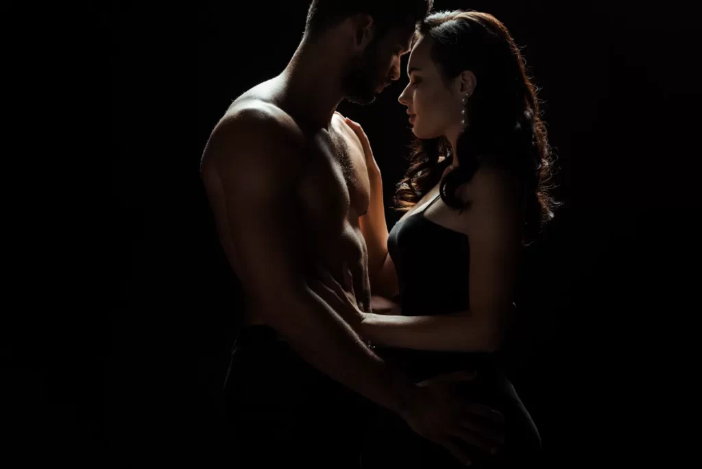 side view of muscular man touching attractive woma utc