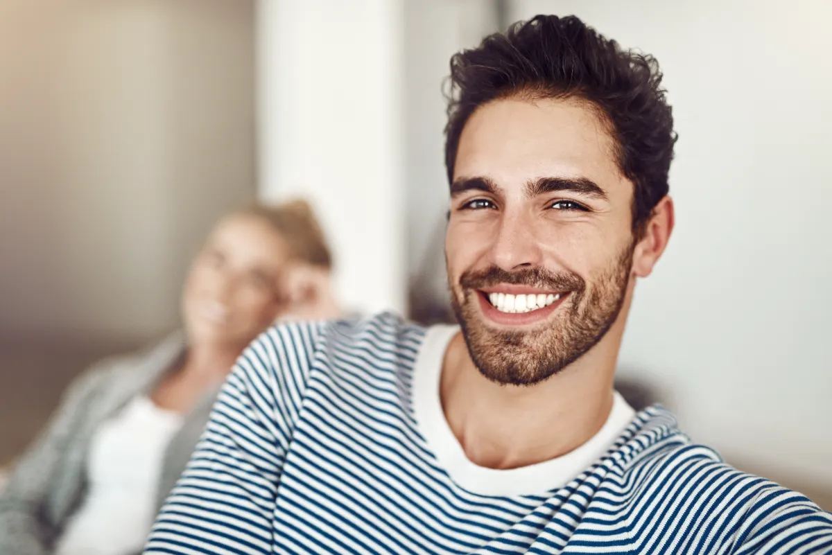 smiling man with blue striped shirt in home utc