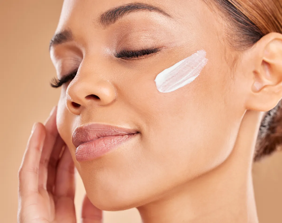 Woman with moisturizer on her cheek