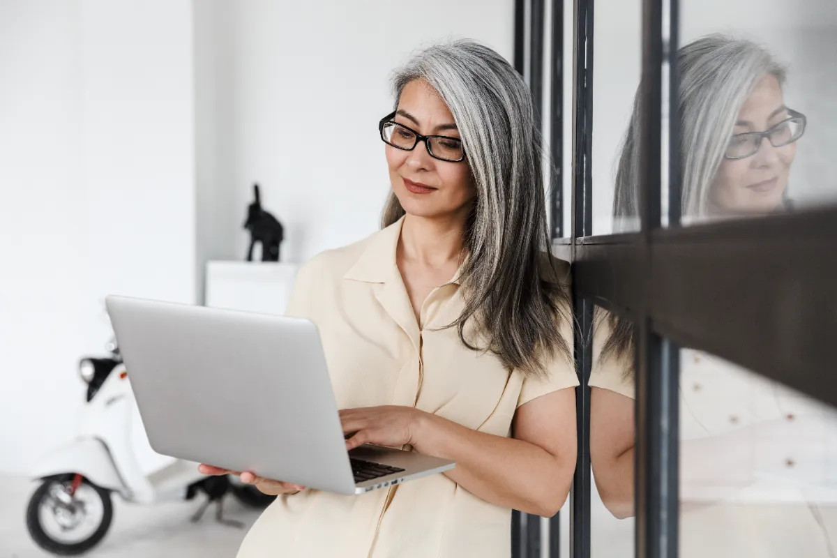 professional woman working on laptop in office utc