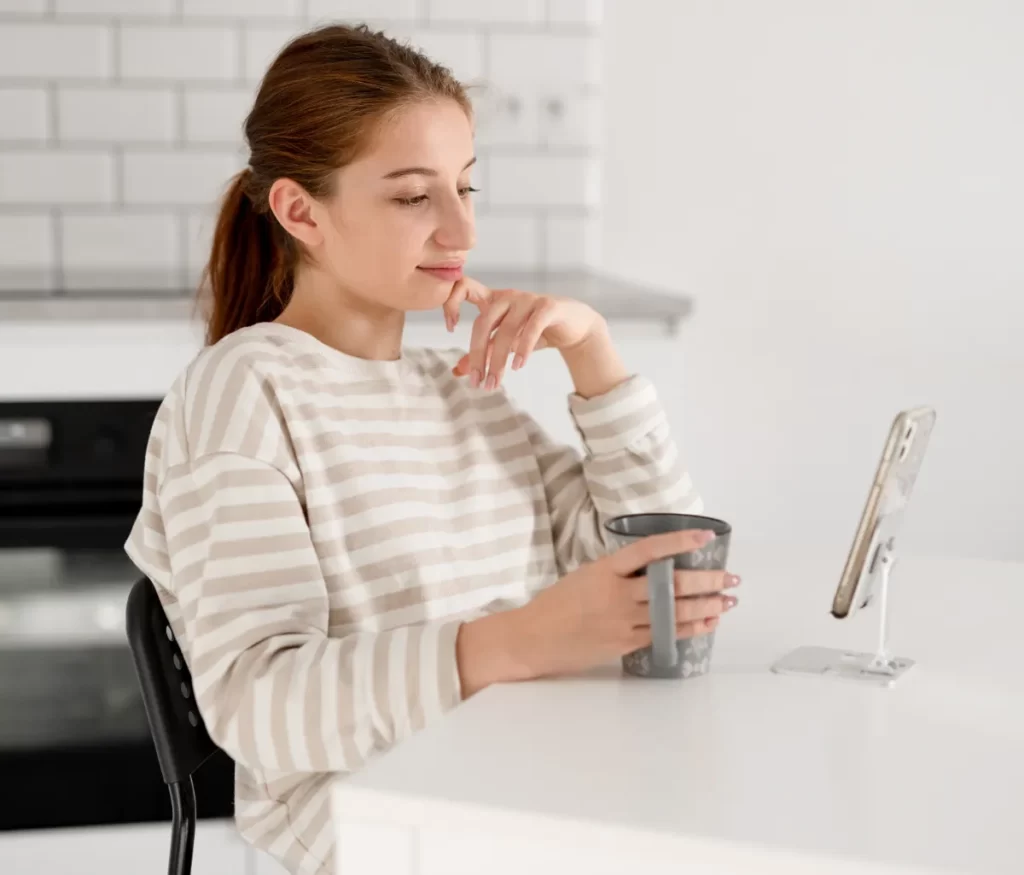 woman relaxing at home with coffee and phone utc