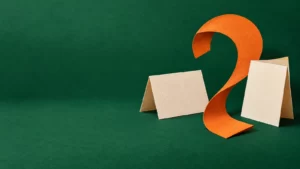 Emerald and orange paper collage of blank cards and a curved paper shape.