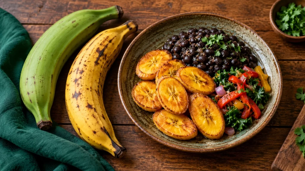 Green and ripe plantains beside cooked slices, beans and vegetables.